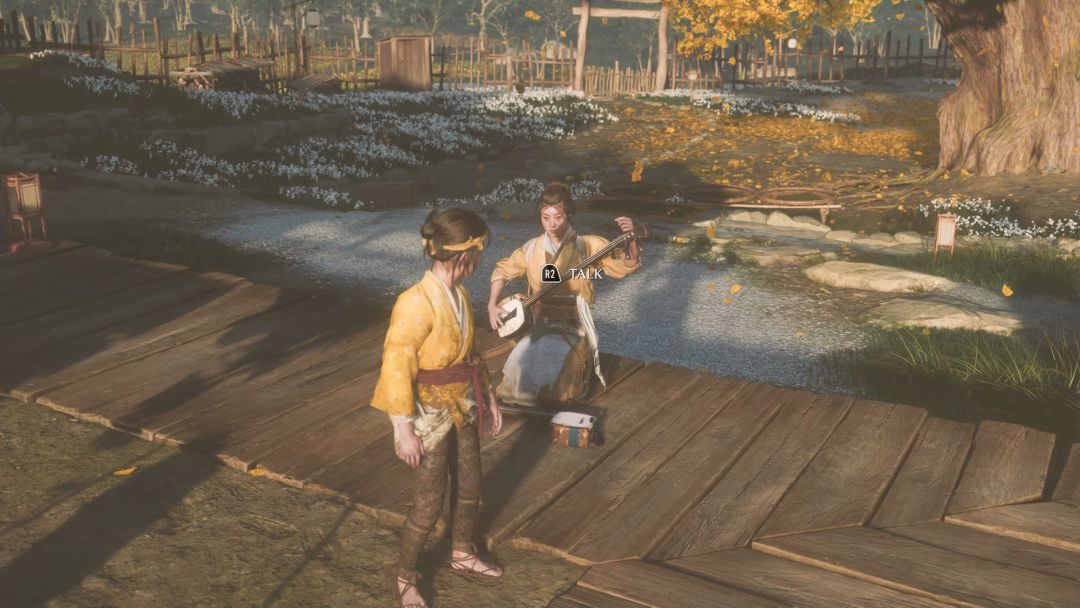 Yone sits on the back deck of the house, holding the shamisen lute.