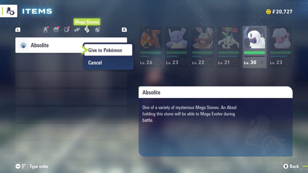 A menu screen, with the Absolite item selected to be given to Absol.