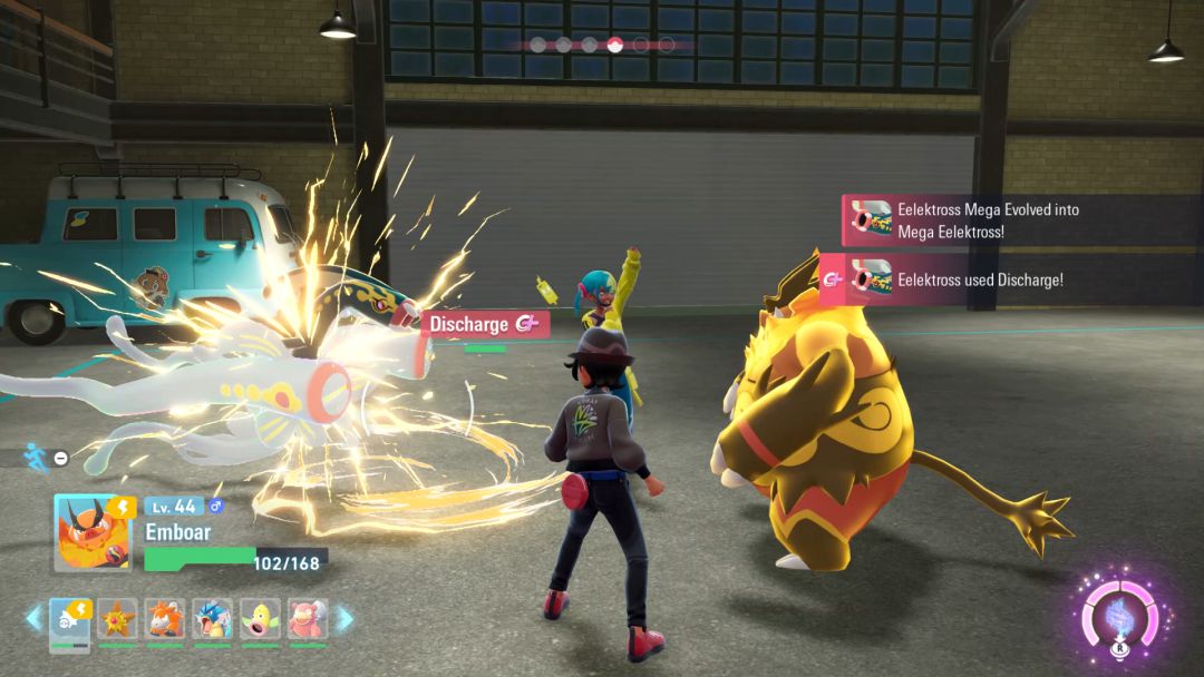 As the Pokemon Trainer watches, an Eelektross with Mega Evolution engaged faces off against Emboar.