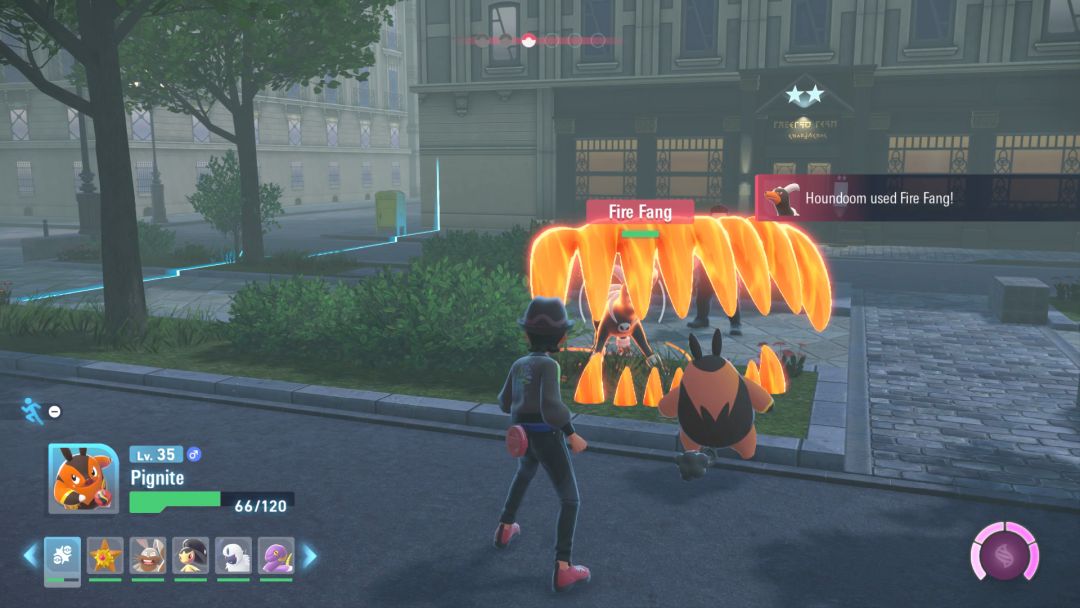 Pignite and Houndoom face off against each other, as the Houndoom attacks with the blazing red teeth of its Fire Fang move.
