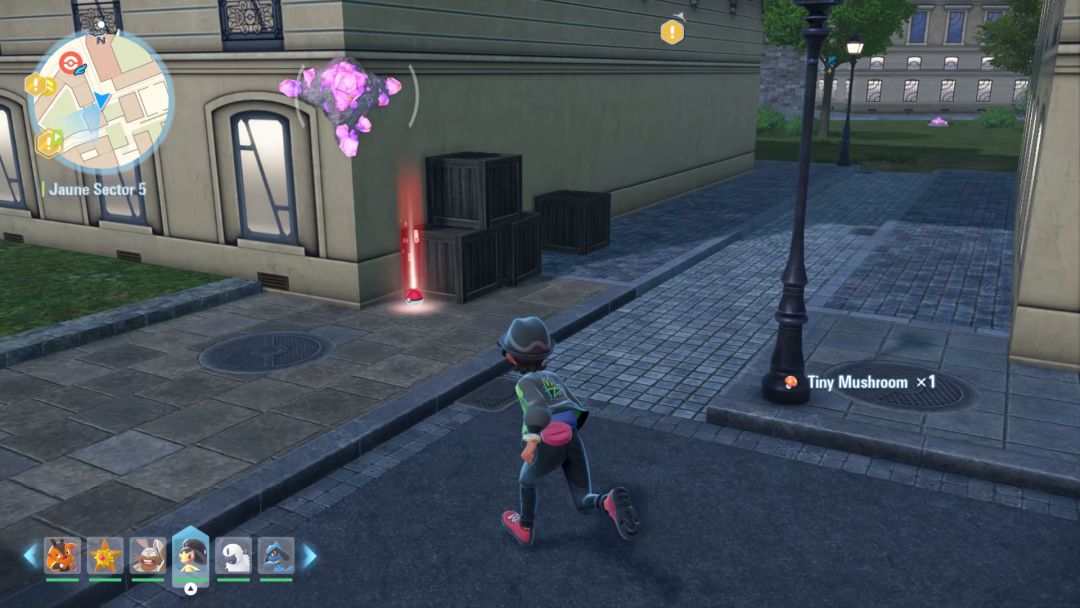 The Pokemon Trainer runs along a street and veers right to head through an opening that leads to the park.