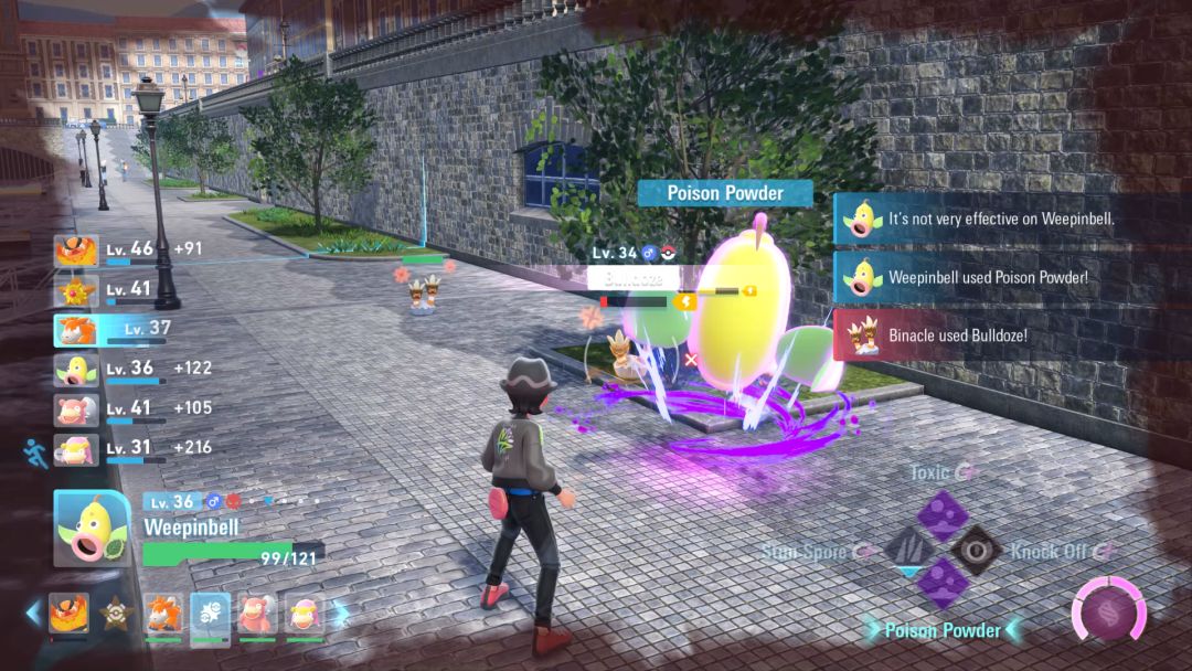 A Weepinbell floats in the air over several Binacle enemies that are positioned along a grass flowerbed and some asphalt.
